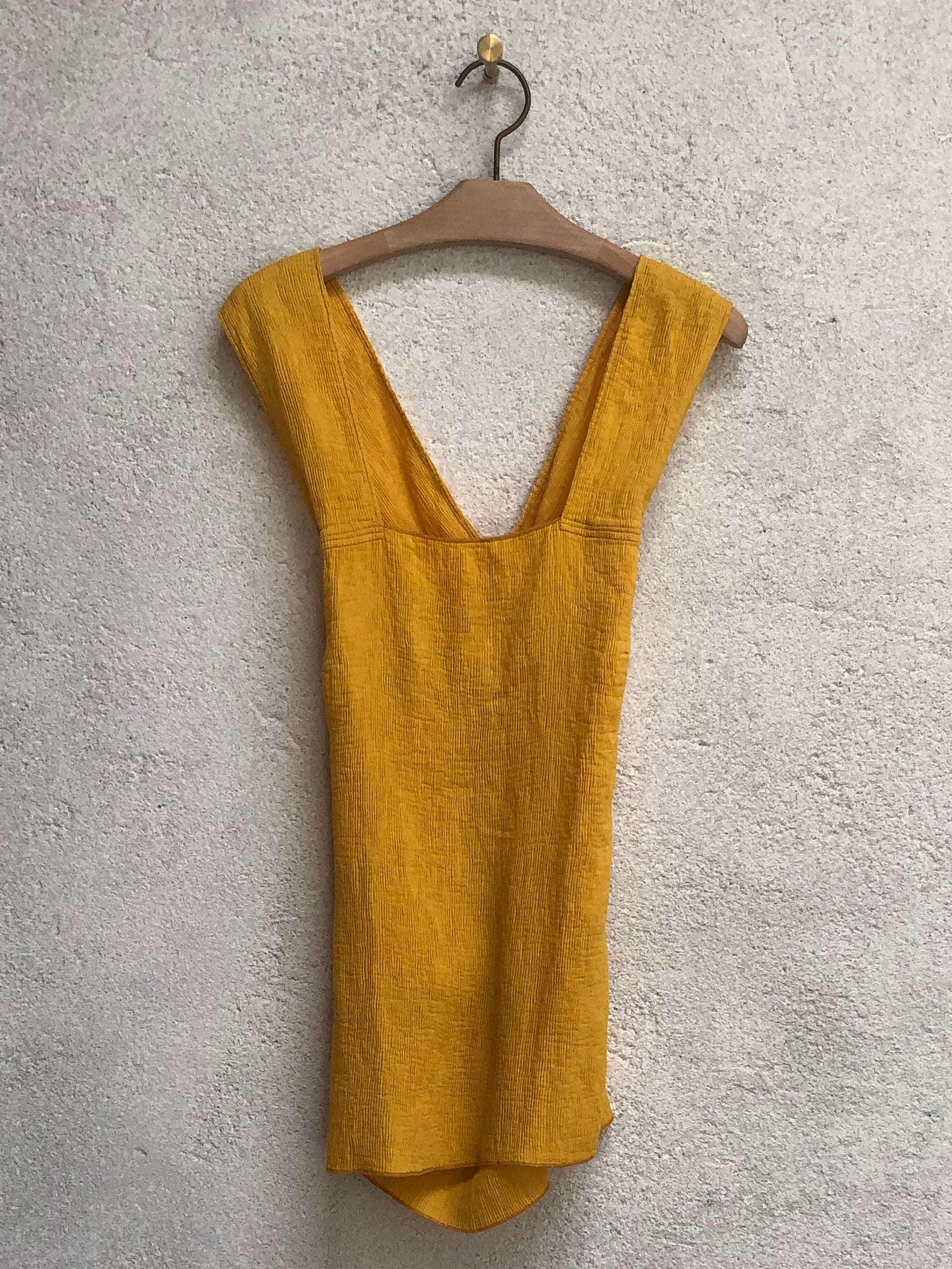 Golden Yellow Fortuny Pleats Apron Top Full Front On A Hanger View
