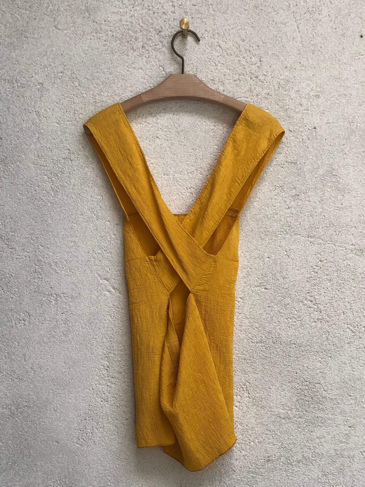 Golden Yellow Fortuny Pleats Apron Top Full Back On A Hanger View
